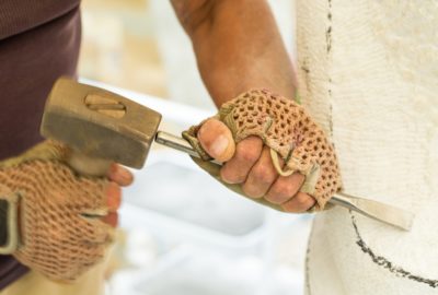 Sculptor hands while working with the tools. Selective focus. Photo can be used as a whole background.